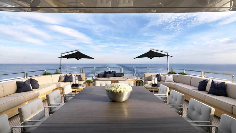 a table with chairs and a large umbrella on it aboard SEALION Yacht for Sale