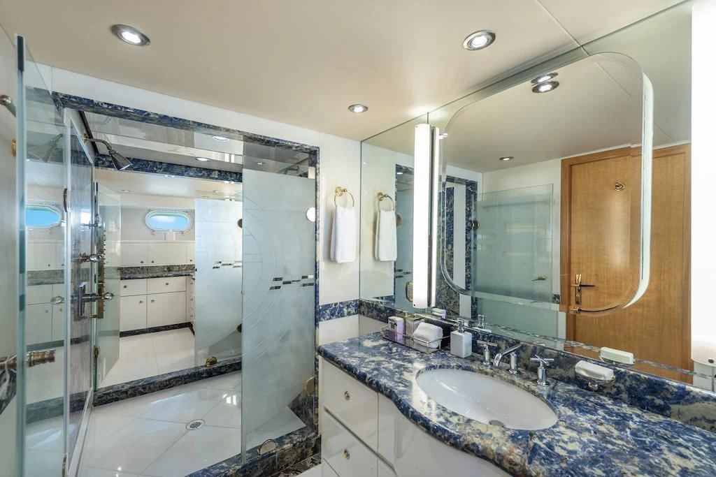 a bathroom with a large mirror aboard SURINA Yacht for Sale