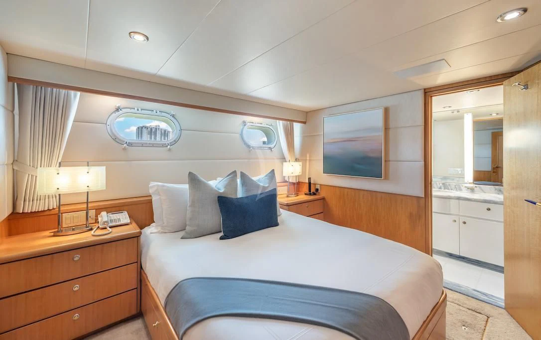 a bedroom with a bed and a television on the wall aboard SURINA Yacht for Sale