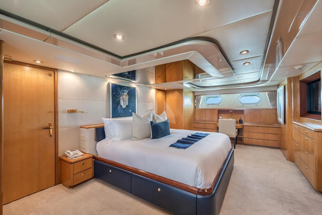 a room with a bed and a desk aboard SURINA Yacht for Sale