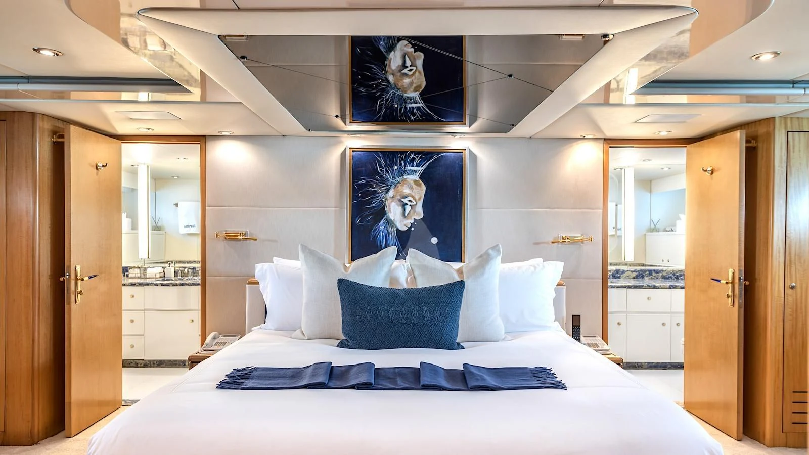 a bedroom with a large mirror aboard SURINA Yacht for Sale