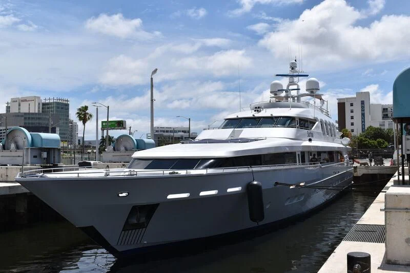 a large white boat in a harbor aboard SURINA Yacht for Sale