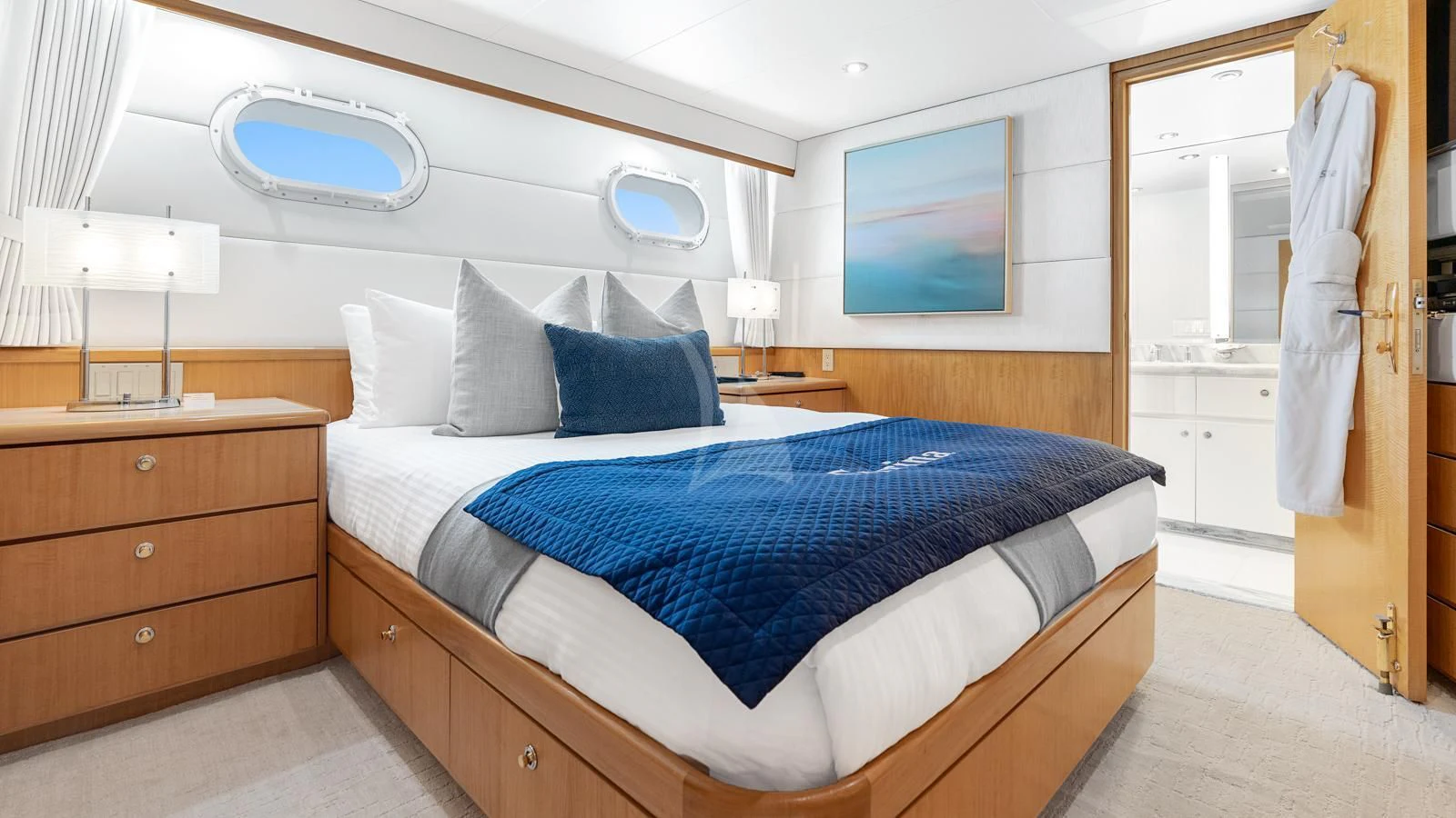 a bedroom with a bed and a dresser aboard SURINA Yacht for Sale