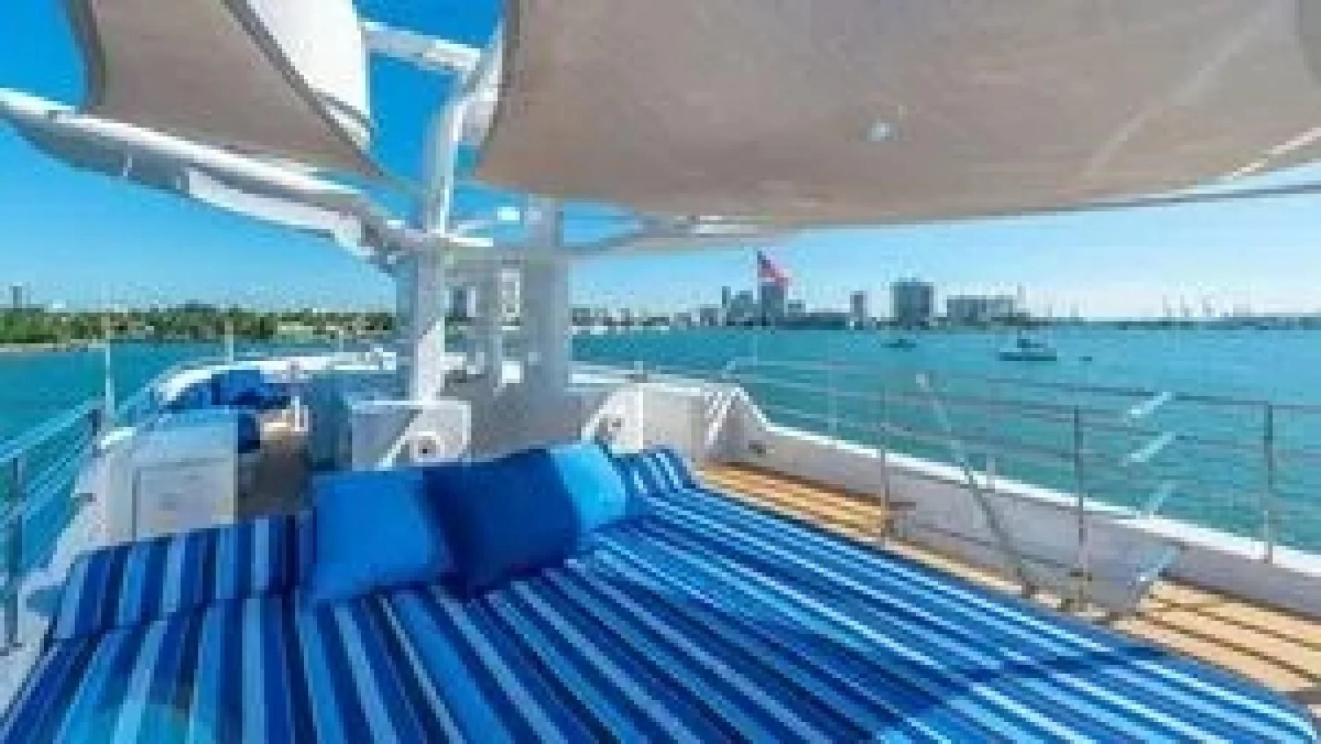 a deck with a view of a city and water aboard SURINA Yacht for Sale