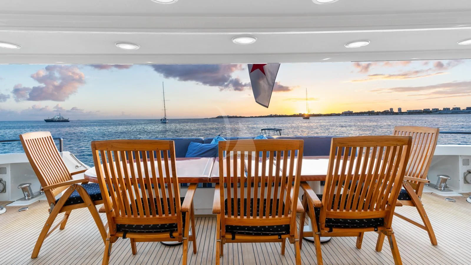 a group of chairs on a deck overlooking a body of water aboard SURINA Yacht for Sale