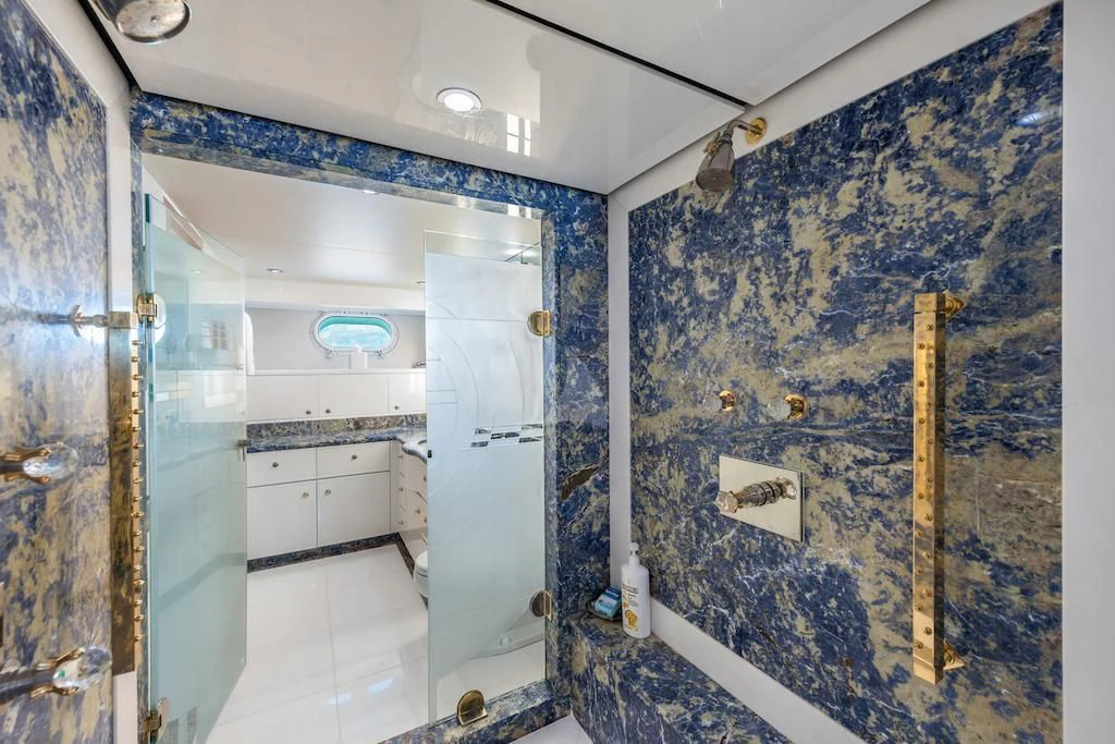 a bathroom with blue walls aboard SURINA Yacht for Sale