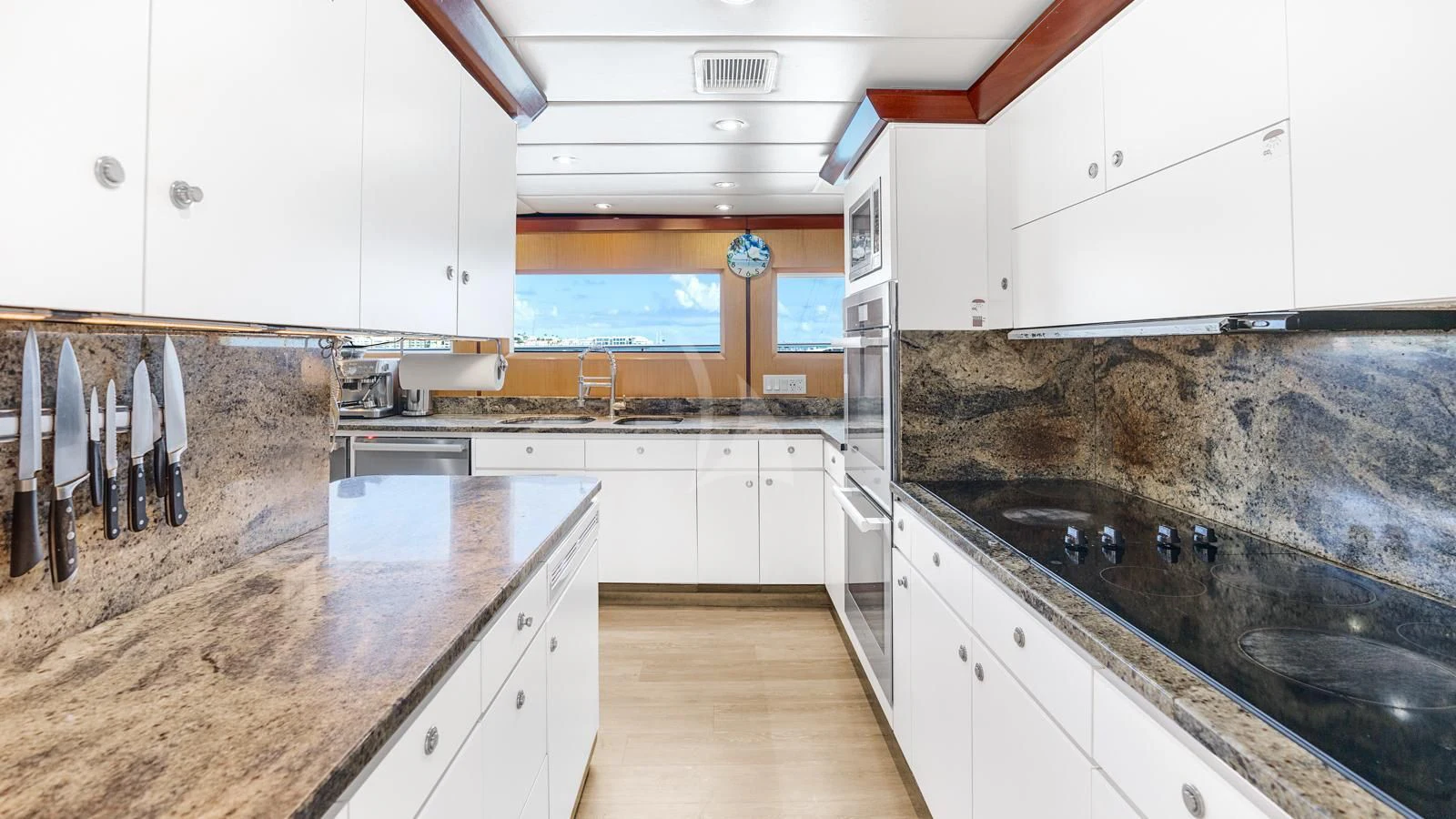a kitchen with white cabinets aboard SURINA Yacht for Sale