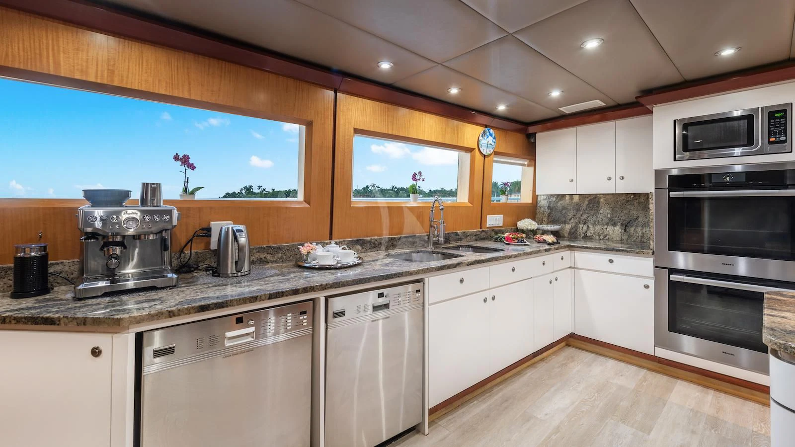a kitchen with white cabinets aboard SURINA Yacht for Sale