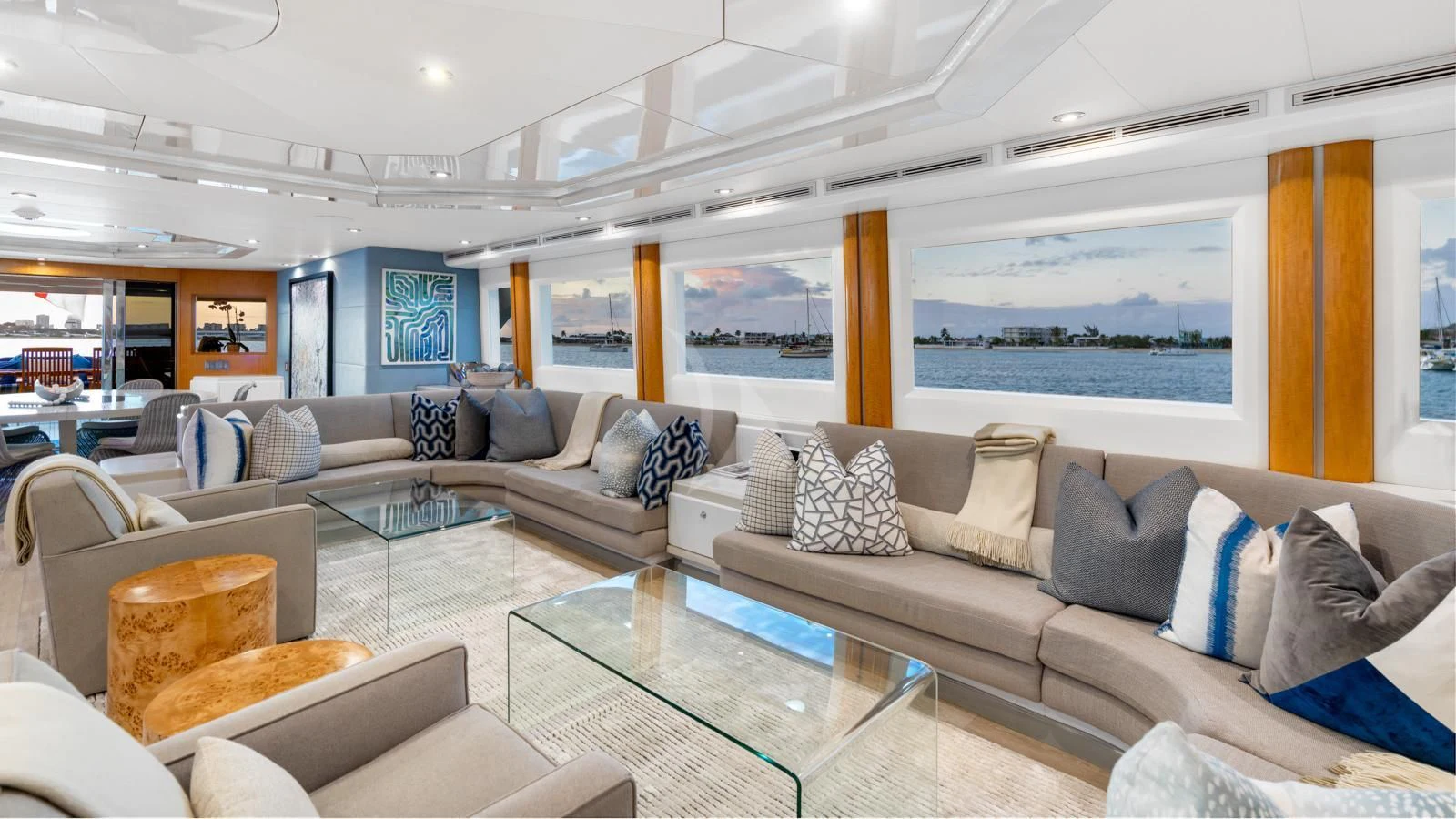 a living room with a large glass table and a large window aboard SURINA Yacht for Sale