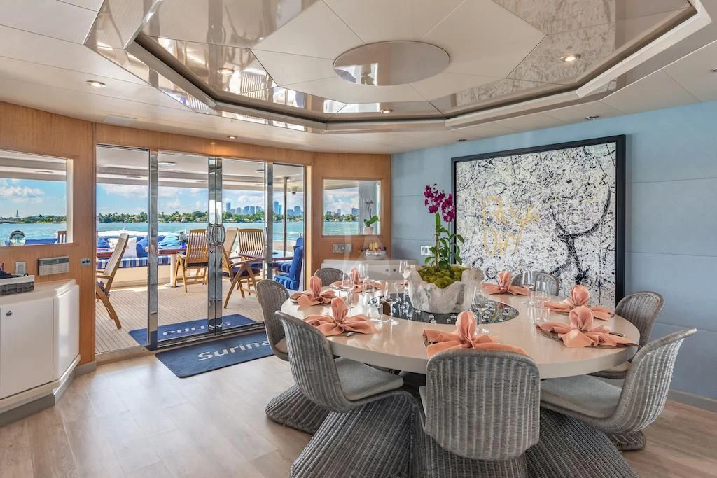 a large room with a table and chairs aboard SURINA Yacht for Sale