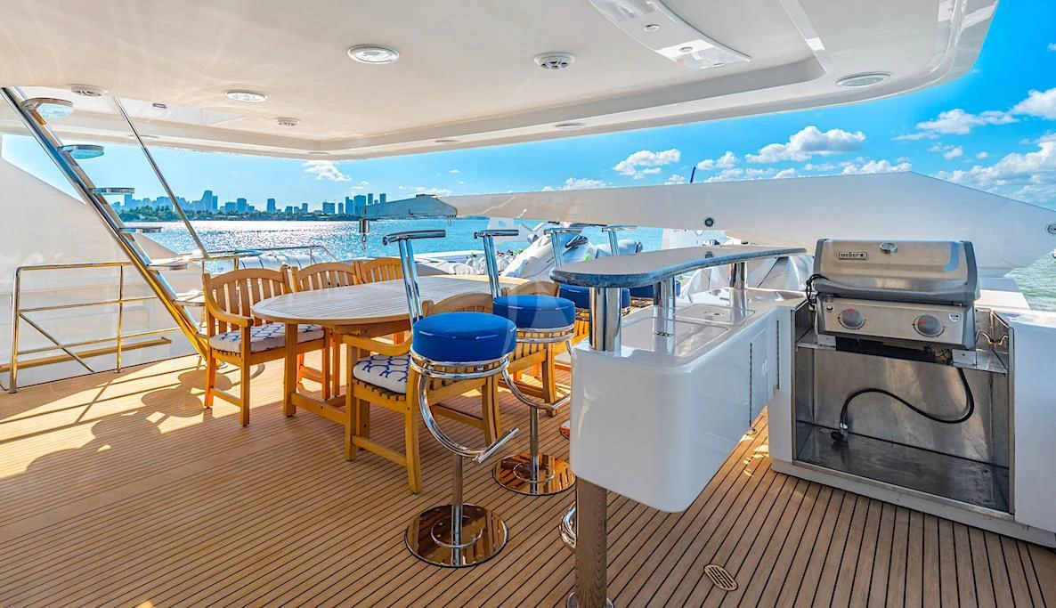 a deck with a table and chairs aboard SURINA Yacht for Sale