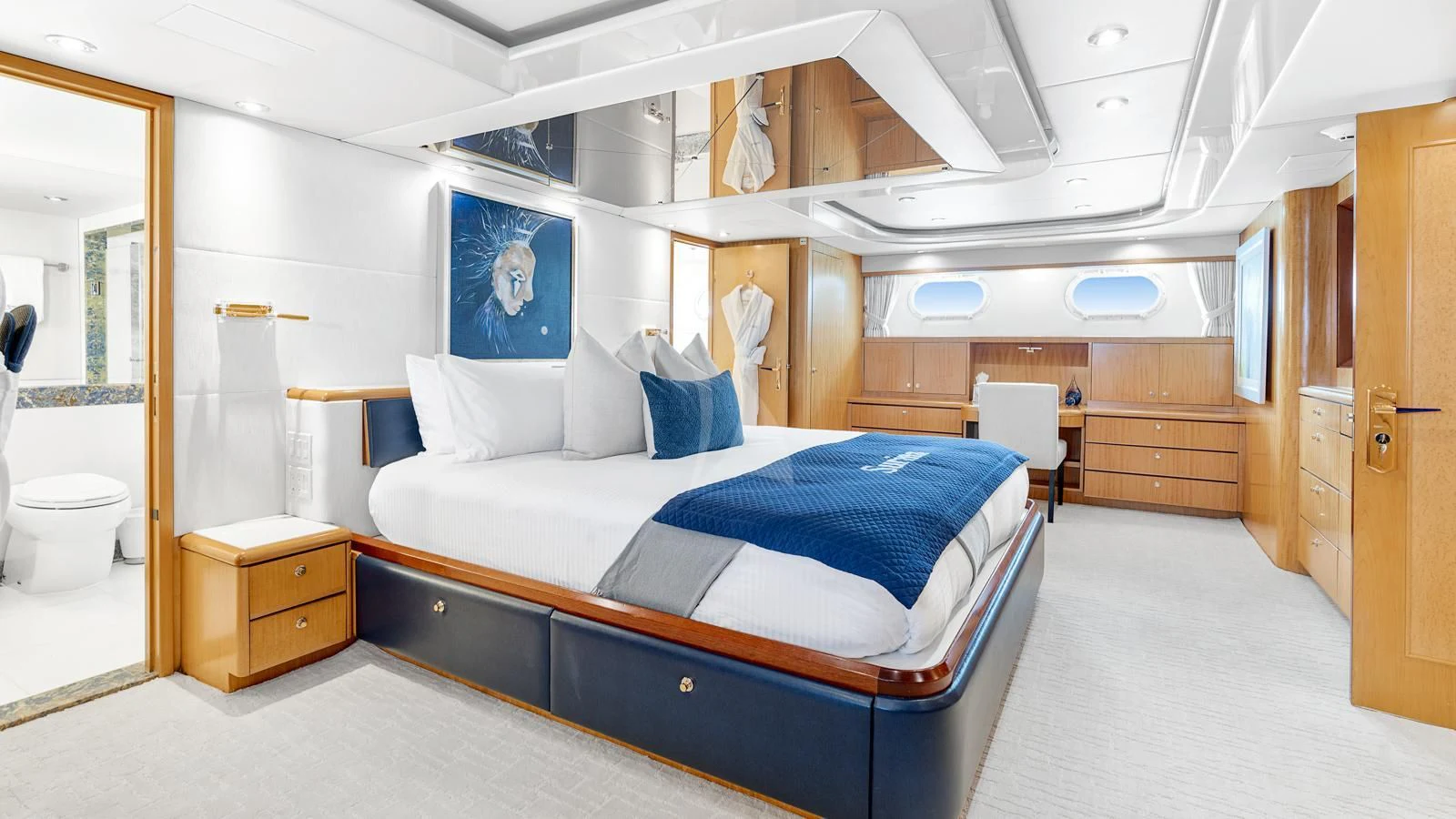 a bedroom with a bed and a desk aboard SURINA Yacht for Sale