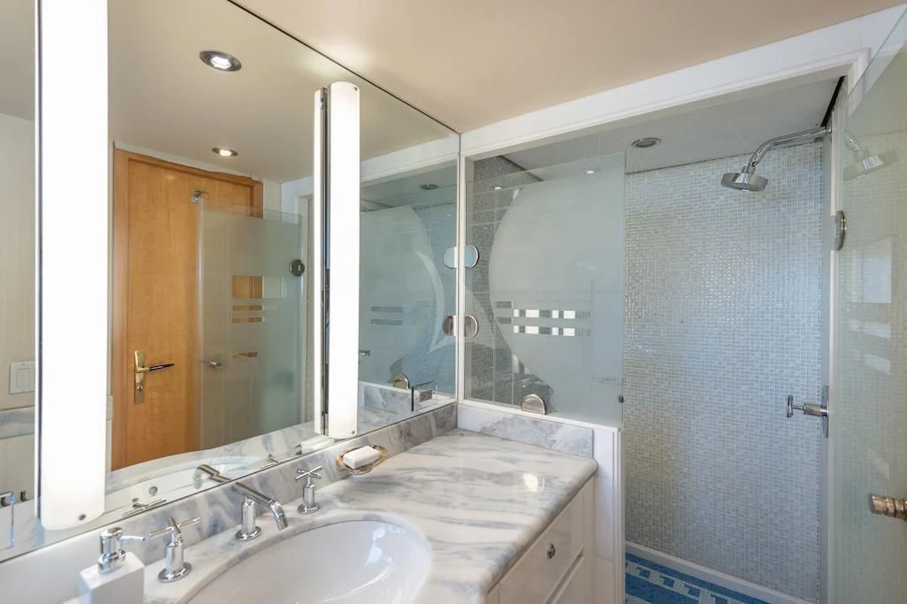 a bathroom with a large mirror aboard SURINA Yacht for Sale