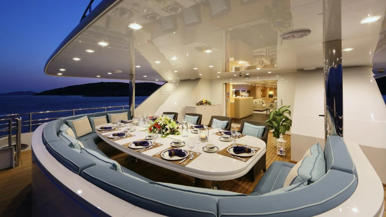 a large white dining table with a large white table and chairs aboard EGO Yacht for Sale
