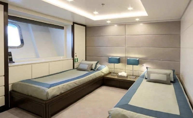a room with a bed and a chair aboard EGO Yacht for Sale