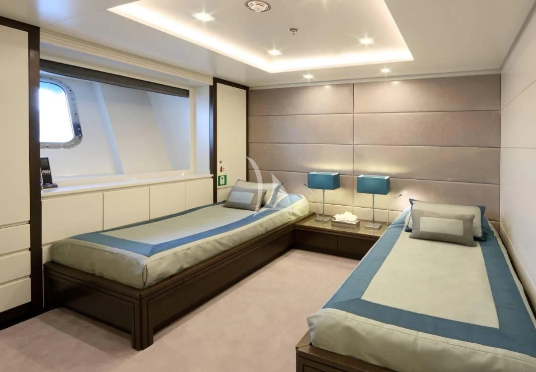 a room with beds and a window aboard EGO Yacht for Sale