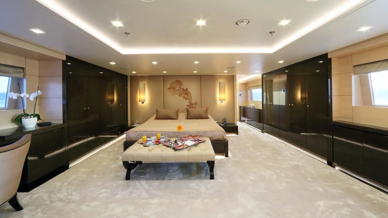 a large living room with a large bed and a large mirror aboard EGO Yacht for Sale