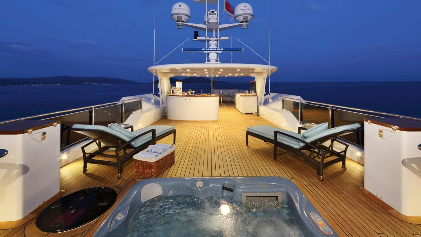 a room with a pool table and chairs aboard EGO Yacht for Sale