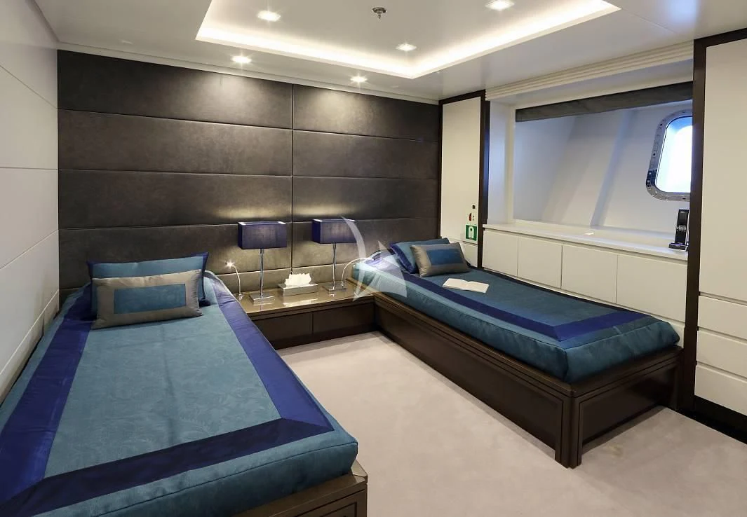 a room with a bed and a desk aboard EGO Yacht for Sale