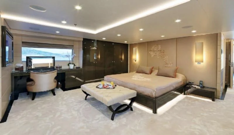 a hotel room with a bed and a tv aboard EGO Yacht for Sale