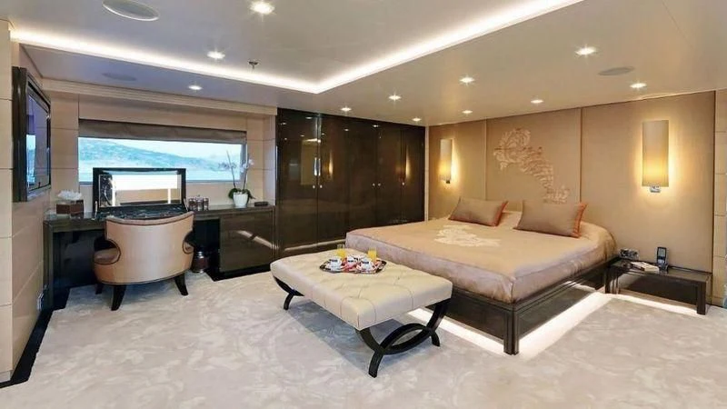 a large hotel room with a bed and a large window aboard EGO Yacht for Sale