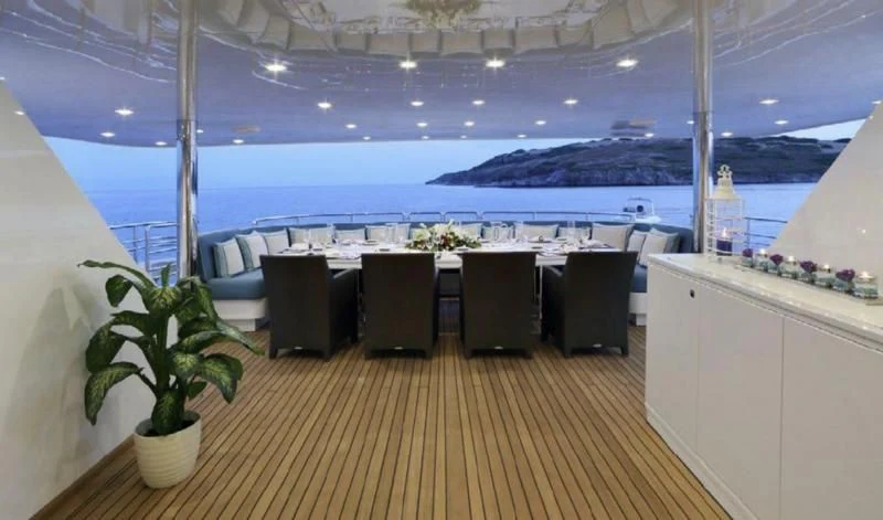 a room with a table and chairs aboard EGO Yacht for Sale