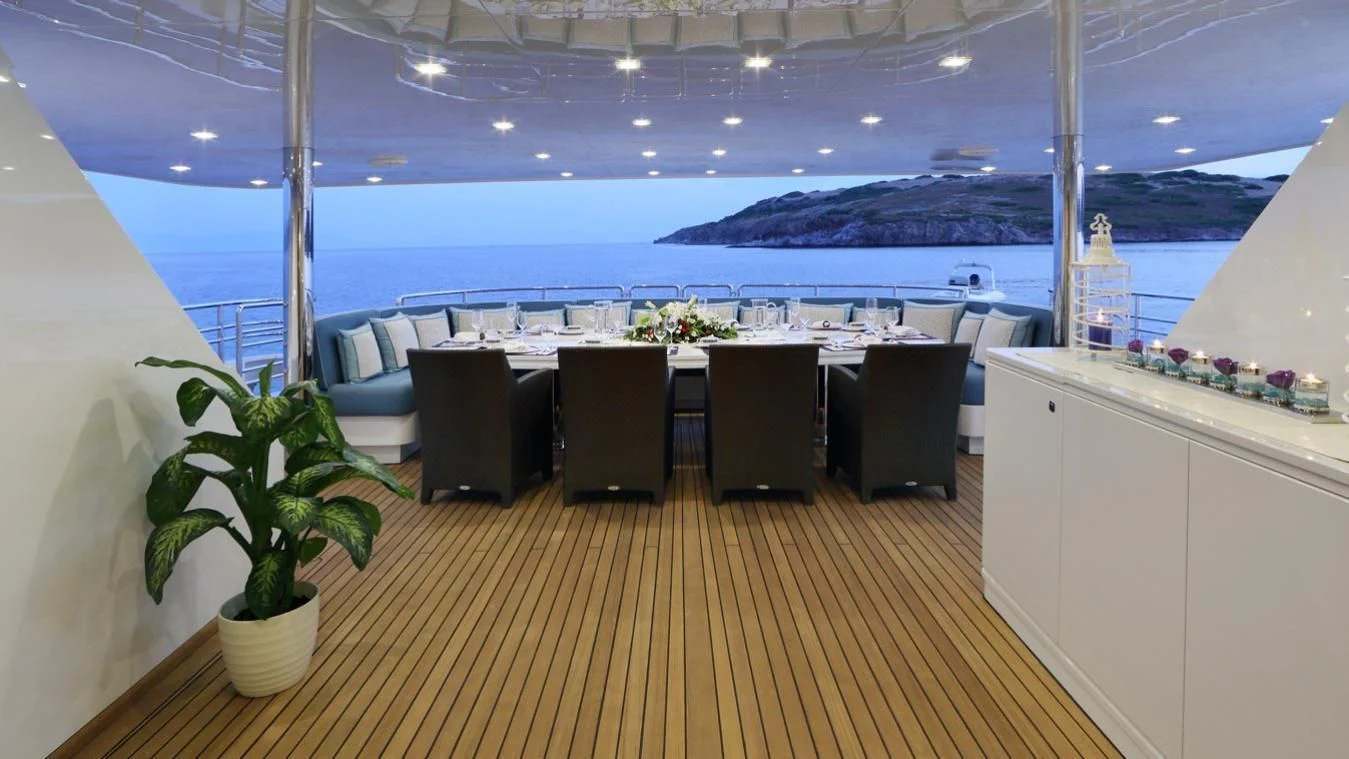 a room with a table and chairs aboard EGO Yacht for Sale
