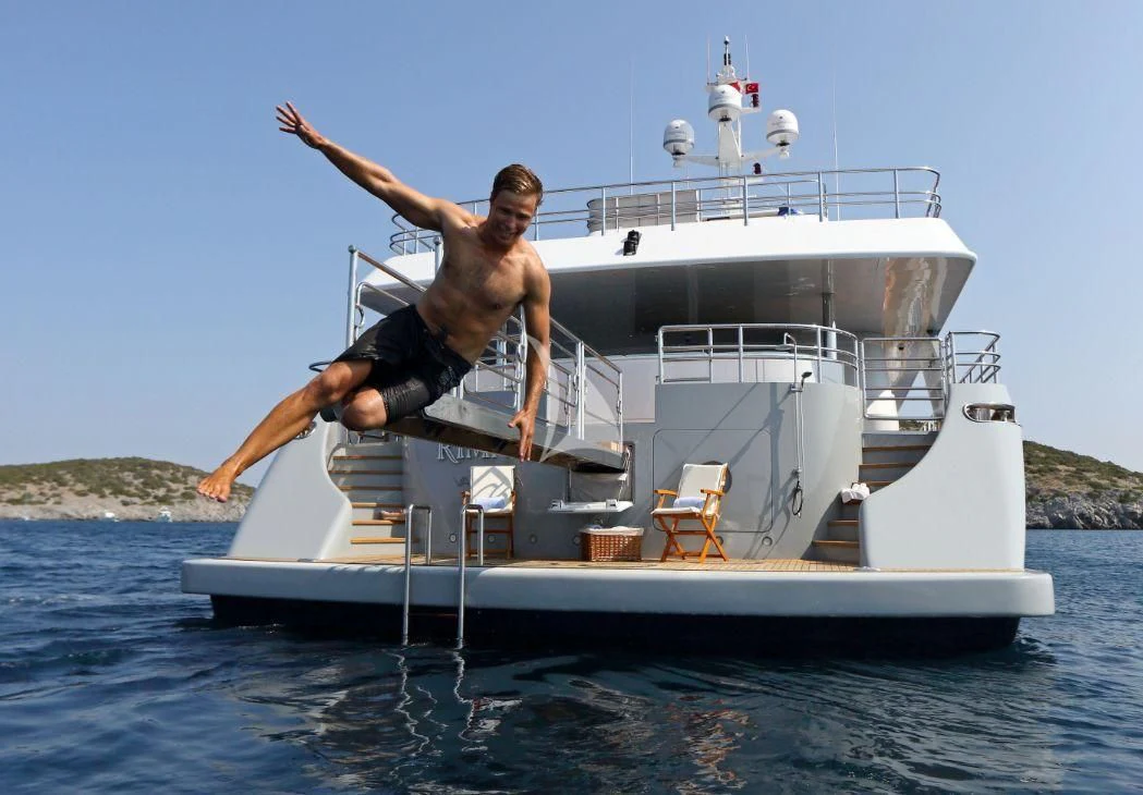 two men jumping off a boat aboard EGO Yacht for Sale