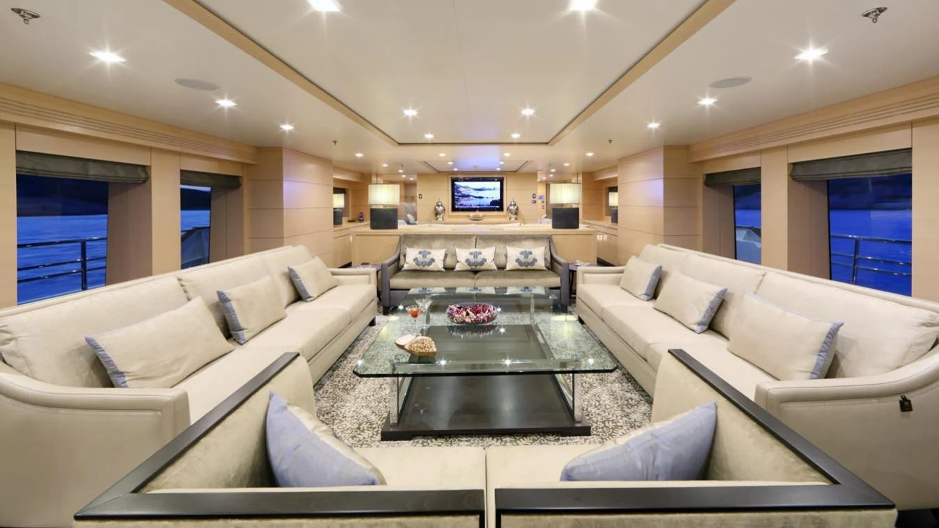 a living room with a large sofa aboard EGO Yacht for Sale