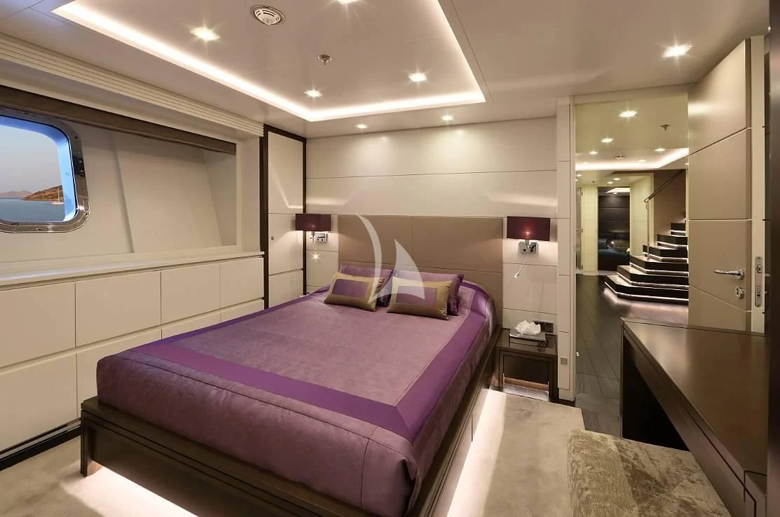 a bedroom with a bed and a desk aboard EGO Yacht for Sale