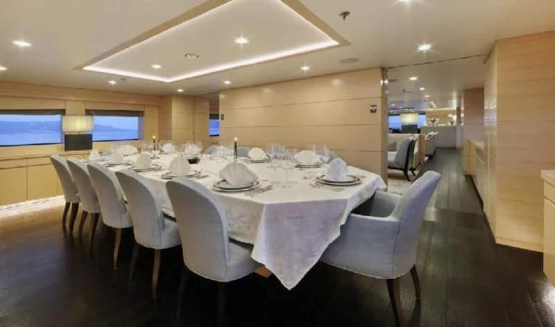 a large room with tables and chairs aboard EGO Yacht for Sale