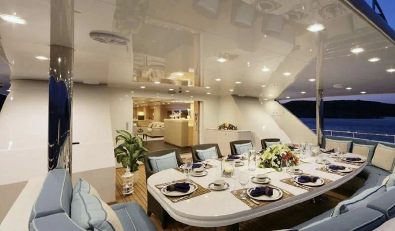 a large room with tables and chairs aboard EGO Yacht for Sale