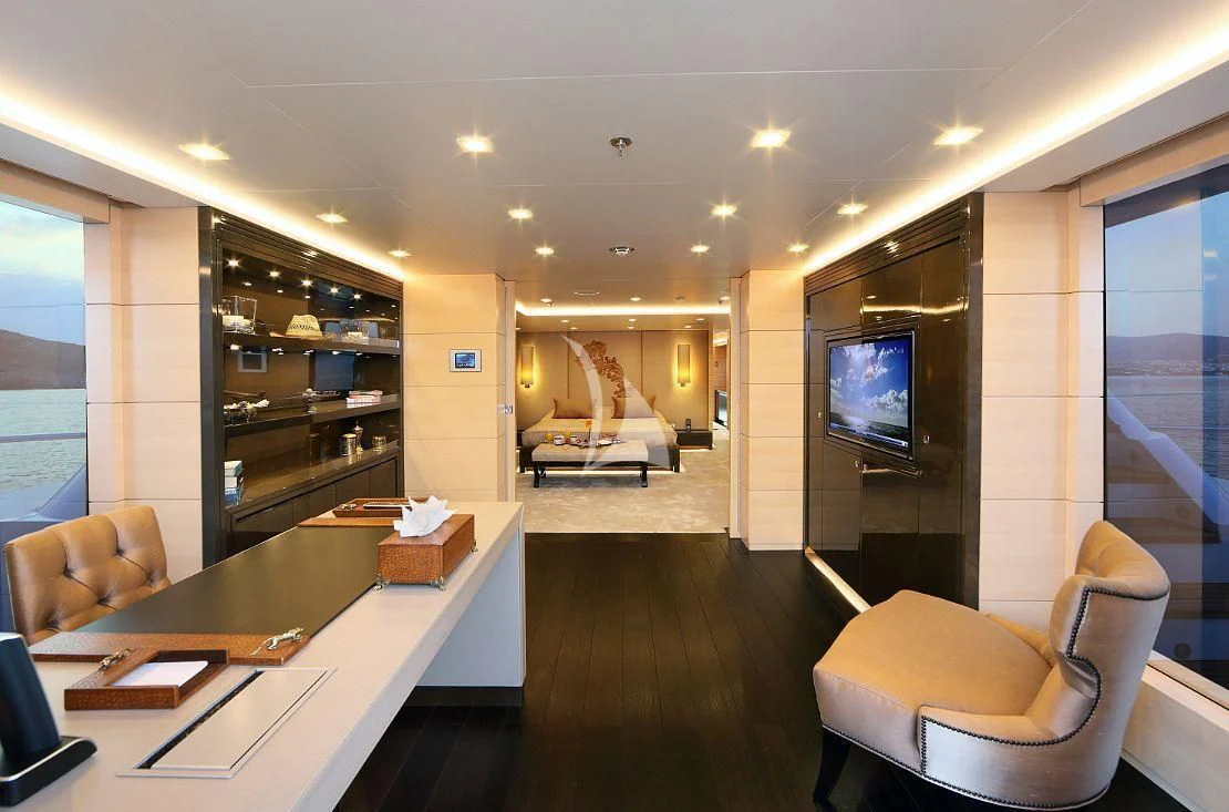 a room with a tv and furniture aboard EGO Yacht for Sale