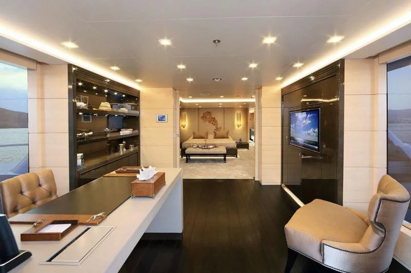 a room with a table chairs and a tv aboard EGO Yacht for Sale