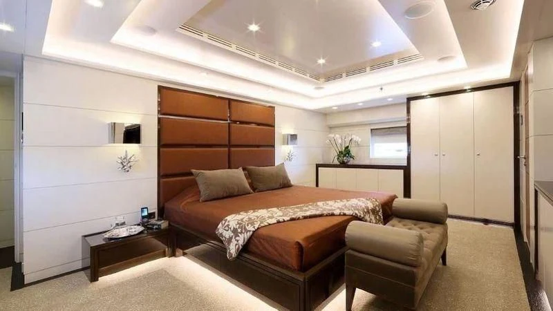 a bedroom with a bed and a desk aboard EGO Yacht for Sale