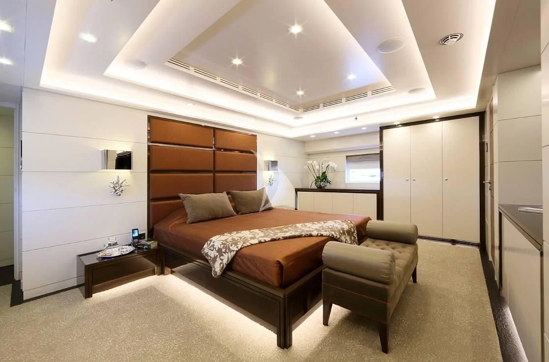 a bedroom with a bed and a desk aboard EGO Yacht for Sale