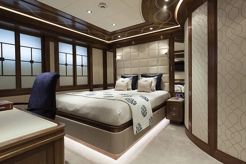 a bedroom with a bed and a chair aboard ARES Yacht for Sale