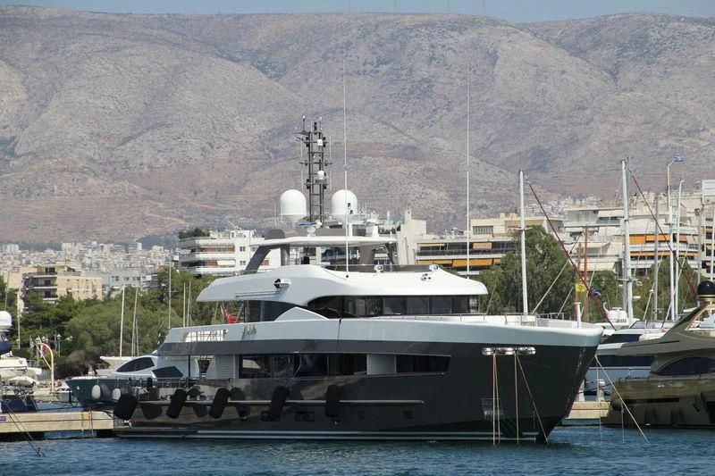 a large boat docked at a pier aboard ARES Yacht for Sale