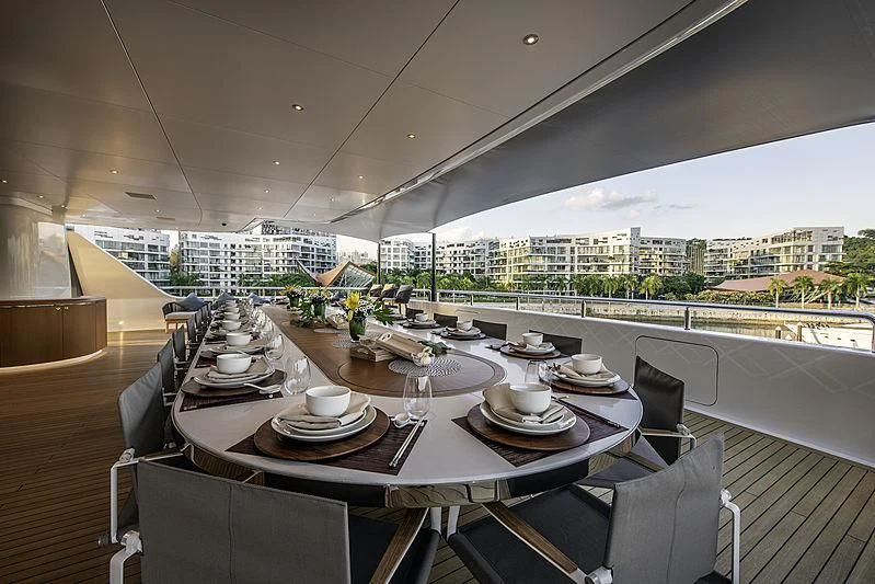 a table with plates and cups on it aboard WHITE RABBIT Yacht for Sale