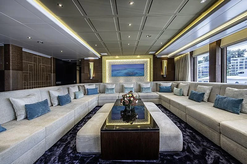 a large room with a couch and a coffee table aboard WHITE RABBIT Yacht for Sale