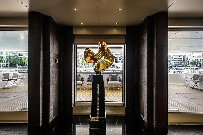 a large glass window with a gold dragon statue on it aboard WHITE RABBIT Yacht for Sale