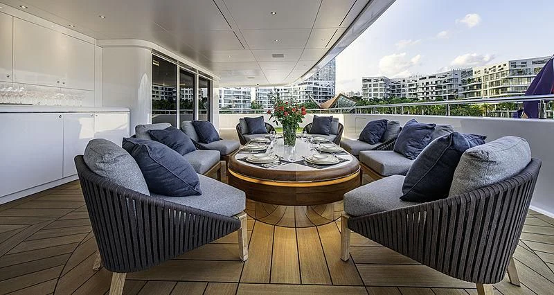 a living room with a table and chairs aboard WHITE RABBIT Yacht for Sale