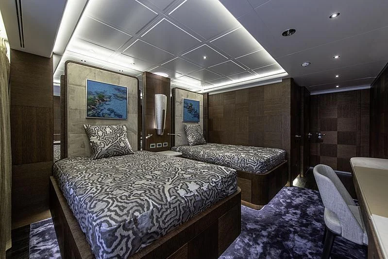 a bedroom with a bed and a couch aboard WHITE RABBIT Yacht for Sale