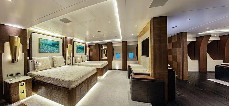 a room with a bed and a desk aboard WHITE RABBIT Yacht for Sale