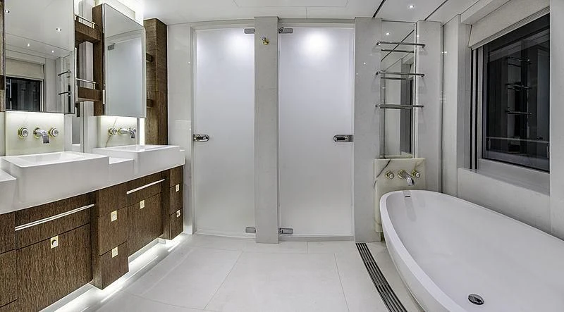 a bathroom with a tub sink and cabinets aboard WHITE RABBIT Yacht for Sale