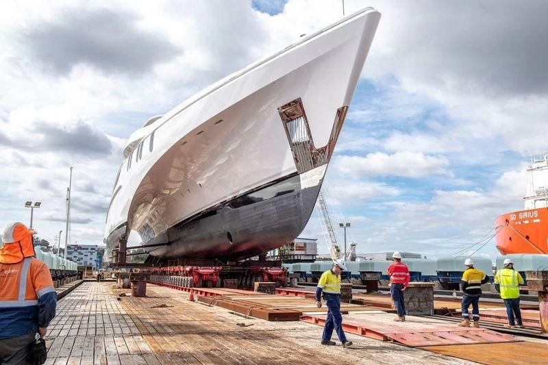 a large ship being loaded aboard WHITE RABBIT Yacht for Sale