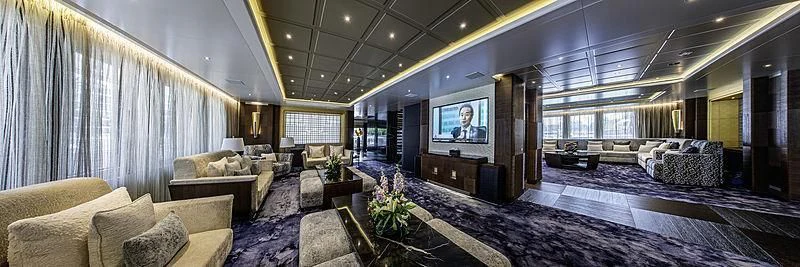 a large living room with a large screen aboard WHITE RABBIT Yacht for Sale