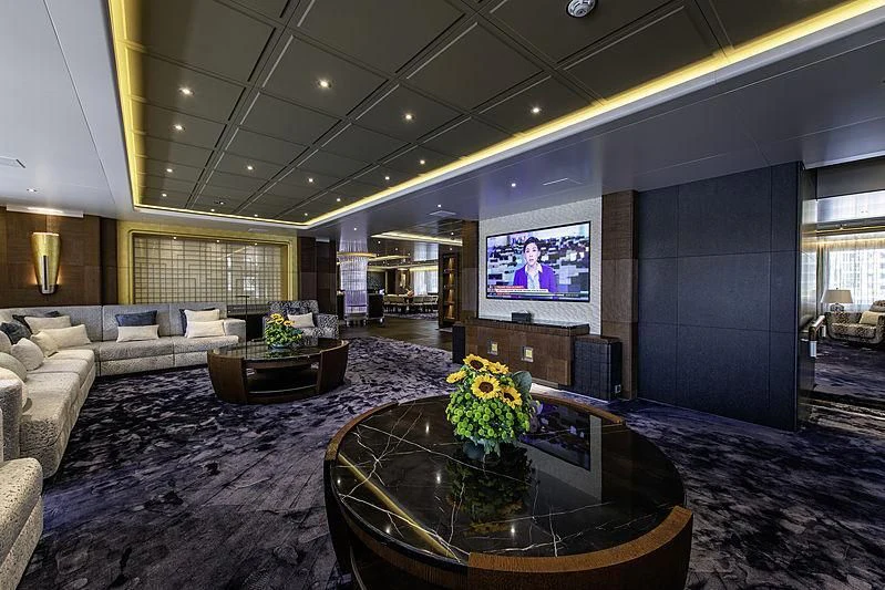 a living room with a large screen aboard WHITE RABBIT Yacht for Sale