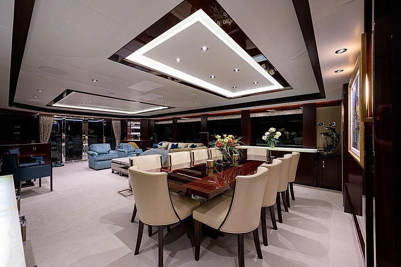 a room with tables and chairs aboard FLAMINGO DAZE Yacht for Sale