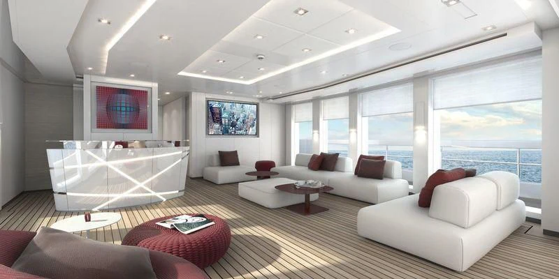 a living room with a large white sofa and a large flat screen television aboard HOME Yacht for Charter